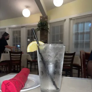 a glass of water with a slice of lemon