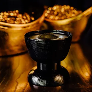 a cup of coffee on a wooden table