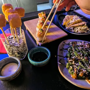 a person holding chopsticks over a plate of food