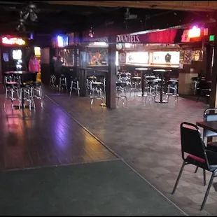 The bar is at the end of the main room, which has quite a few tables, a large dance floor, and a stage.  Live music happens every weekend.