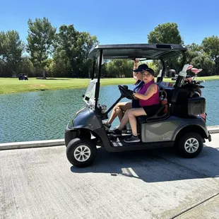 Pushing along in the golf cart to the next hole ‍