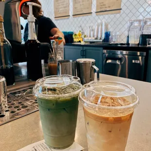 two cups of iced coffee on a counter