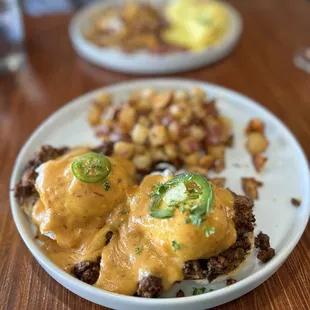 Chorizo eggs Benedict and hubbys   in the background.
