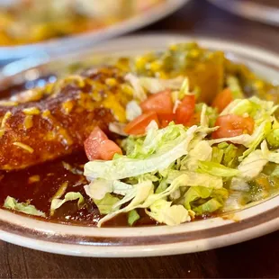 One Simple carne asada beef enchilada topped with green &amp; red sauce. The trick here, is to top it with a EGG. :)...