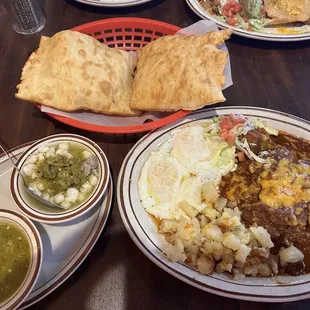 Breakfast plate with beef adobado, sopapillas, pozole, and green sauce.