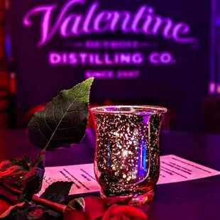 a candle and rose on a table