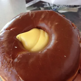 Chocolate donut with bavarian creme in the center.