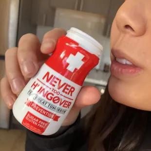 a woman holding a can of never hi - cover