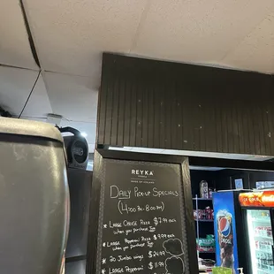 The spiderweb coming down from the ceiling to the drink machine