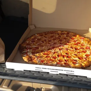Giant pizza barely fits in the back of the SUV