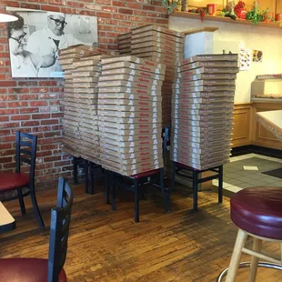stacked pizza boxes in a restaurant