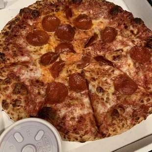 Medium pepperoni pizza with an extra side of sauce