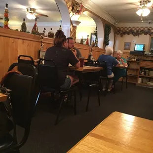 people sitting at tables in a restaurant