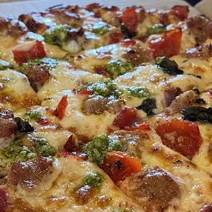 Thin crust sausage, peppadew peppers, fresh basil and dollops of pesto on top.