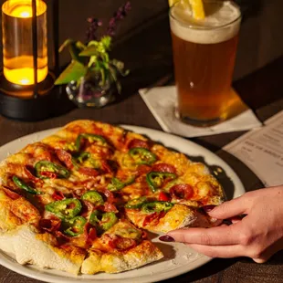 Spicy Meat Lovers Pizza with house-made dough, San Marzano sauce, pepperoni, sausage, jalapeños, Calabrian chili, and mozzarella.