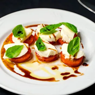 Caprese Salad, Locally grown tomatoes, Fior di latte mozzarella, Fresh basil, topped with Olive oil and Fig balsamic