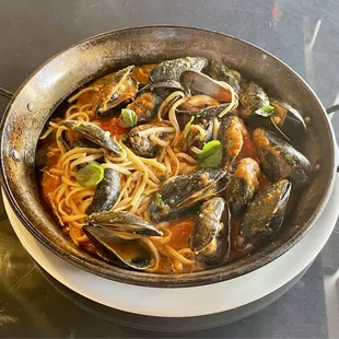 Huge portion of mussels. A freebie because the kitchen forgot to include mussels in my linguine pescatore. Excellent!