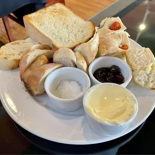 Assortment of house-baked breads with European butter, sea salt, and roasted olives