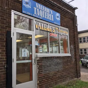 The entrance is just around the corner from the carniceria.