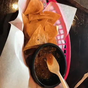 a basket of chips and salsa