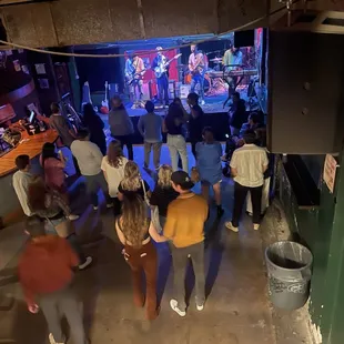 a group of people standing in a bar