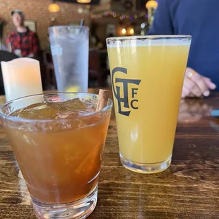 a glass of beer and a glass of orange juice