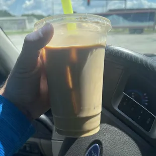 a hand holding a cup of coffee