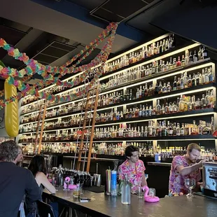 a bar with people sitting at the bar