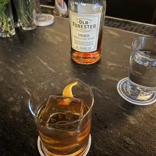 a glass of whiskey and a bottle of whiskey