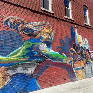 Painted on a building in the alley nearby