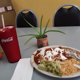 a plate of mexican food and a drink