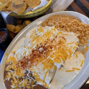 Chicken enchiladas with rice and beans.