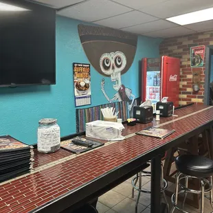 a long table with chairs and a television