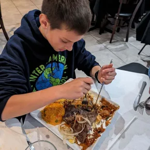 Enthusiastically enjoying the chilaquiles, steak and eggs!