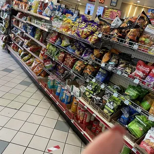 a hand pointing towards a display of snacks