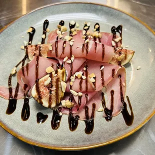 Salty prosciutto topped with fresh sweet figs,  drizzle of balsamic glaze is an irresistible sweet and savory treat!