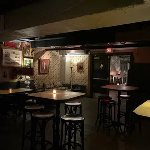 tables and stools in a dimly lit room