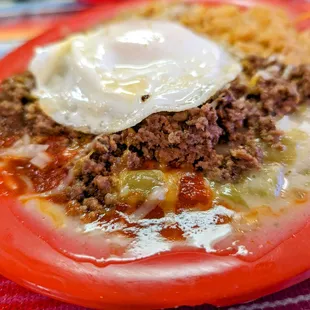 a plate of food with a fried egg on top
