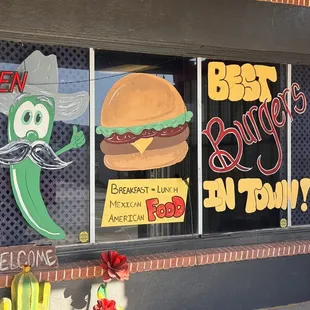 a window with a sign that says best burgers in town
