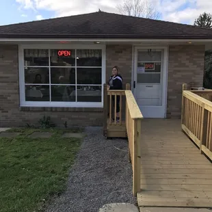 a woman sitting on the porch of a building