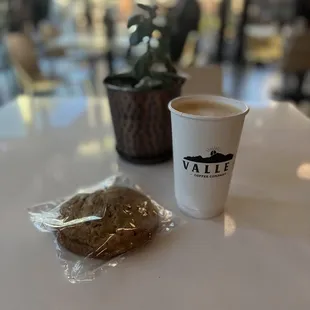 a cup of coffee and a bag of cookies