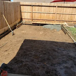 a back yard with a fenced in area