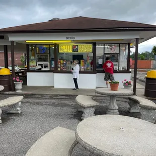 two people standing in front of a store