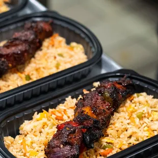 a close up of a tray of chicken and rice