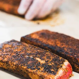 two pieces of salmon on a cutting board