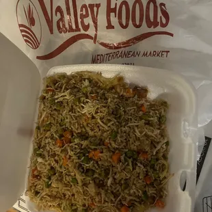 a takeout container of vegetable fried rice