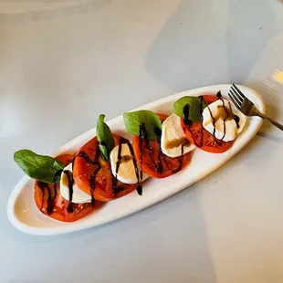 a plate of tomatoes and mozzarella