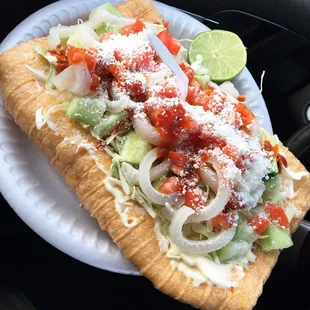 a sandwich on a paper plate