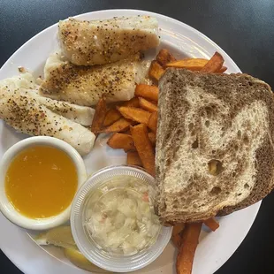 a plate of food including a sandwich, sweet potato fries, and dipping sauce