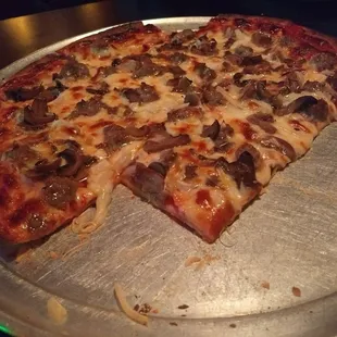 Thin crust cheese sausage mushroom and onion pizza